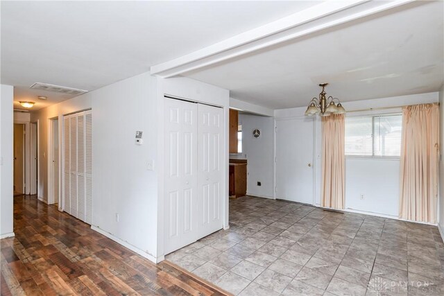 5501 Harshmanville Rd, Dayton, OH 45424 - spare room featuring a chandelier and baseboards