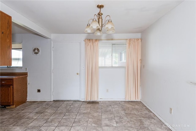 5501 Harshmanville Rd, Dayton, OH 45424 - unfurnished dining area featuring a chandelier and healthy amount of natural light
