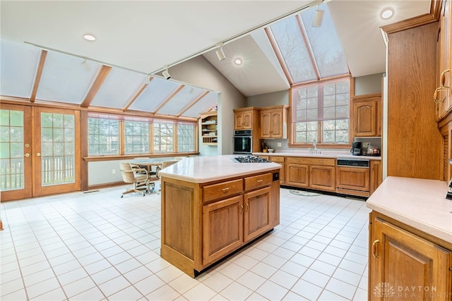 514 Shambord Cir, Kettering, OH 45429 - kitchen featuring oven, a skylight, lofted ceiling, light tile patterned floors, and light countertops
