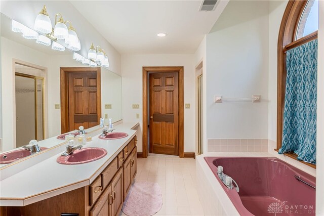 514 Shambord Cir, Kettering, OH 45429 - bathroom featuring double vanity, a bath, a stall shower, tile patterned flooring, and recessed lighting