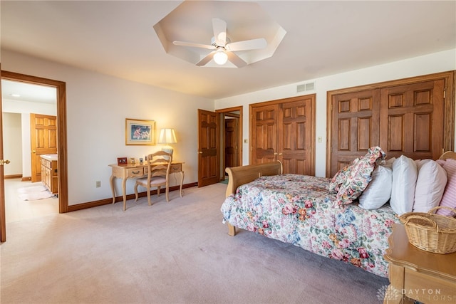514 Shambord Cir, Kettering, OH 45429 - bedroom featuring two closets, light carpet, baseboards, ensuite bathroom, and a ceiling fan