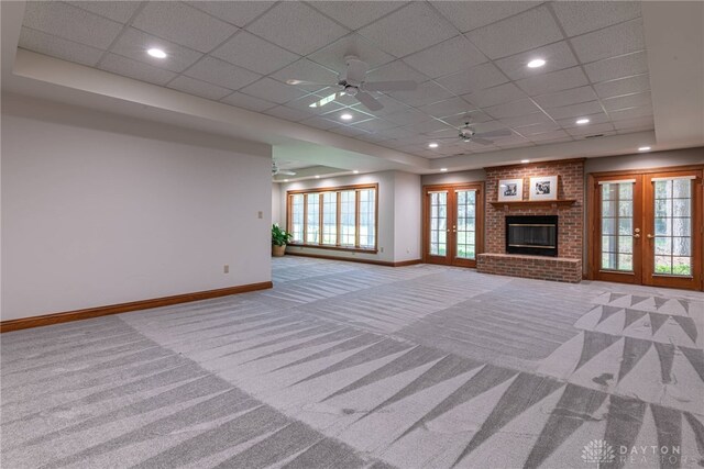 514 Shambord Cir, Kettering, OH 45429 - unfurnished living room featuring french doors, carpet, baseboards, a drop ceiling, and a ceiling fan