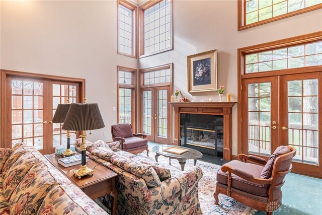 514 Shambord Cir, Kettering, OH 45429 - living room featuring french doors, a towering ceiling, a fireplace with flush hearth, and carpet