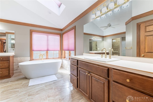 514 Shambord Cir, Kettering, OH 45429 - bathroom with lofted ceiling, a skylight, a freestanding tub, vanity, and a ceiling fan