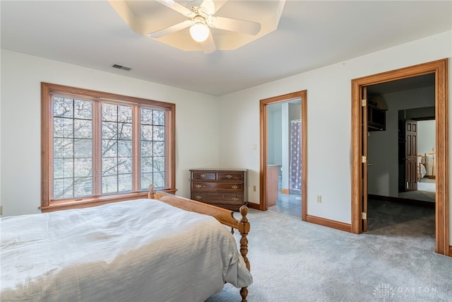 514 Shambord Cir, Kettering, OH 45429 - carpeted bedroom with a walk in closet, baseboards, ensuite bathroom, ceiling fan, and a closet