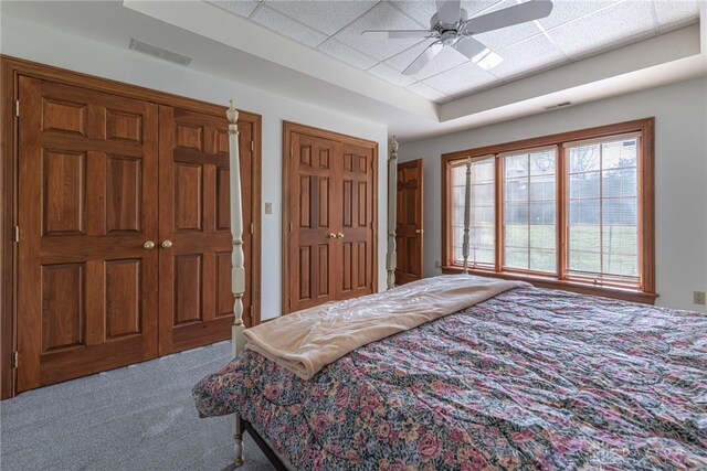 514 Shambord Cir, Kettering, OH 45429 - carpeted bedroom with a drop ceiling, a ceiling fan, and two closets