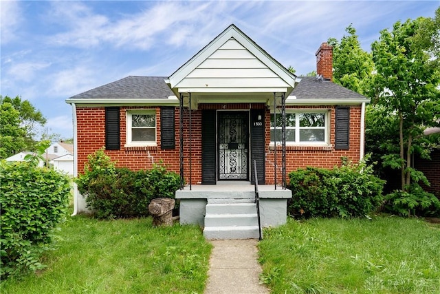 1533 Weaver St, Dayton, OH 45417 - bungalow-style home featuring brick siding, a chimney, and a shingled roof