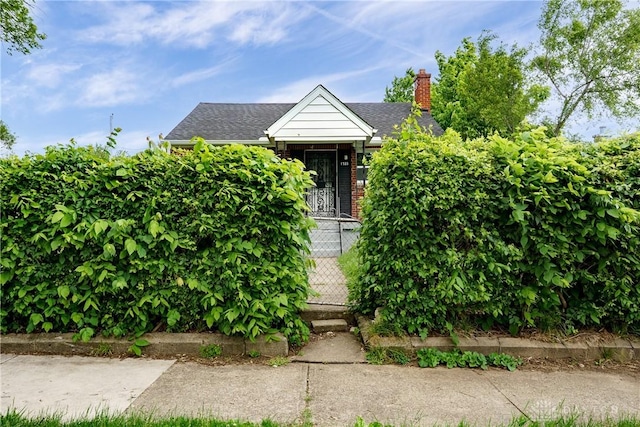 1533 Weaver St, Dayton, OH 45417 - obstructed view of property with roof with shingles, a chimney, and brick siding