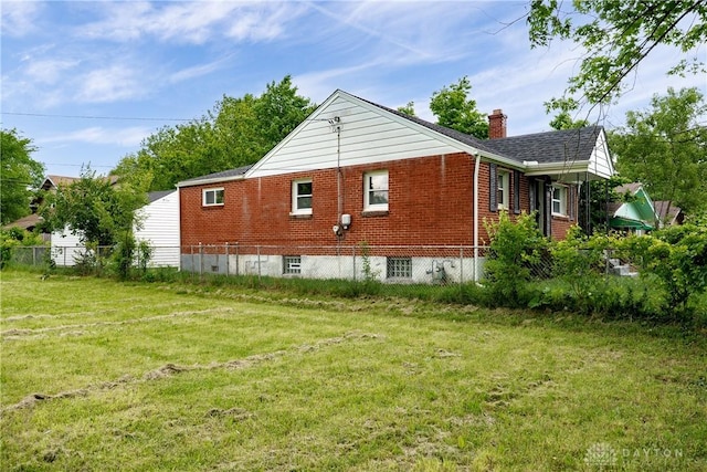 1533 Weaver St, Dayton, OH 45417 - view of property exterior with a chimney and brick siding