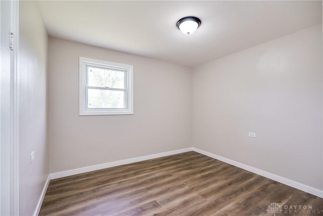 1533 Weaver St, Dayton, OH 45417 - spare room featuring baseboards and dark wood finished floors