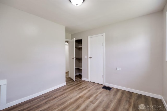1533 Weaver St, Dayton, OH 45417 - unfurnished bedroom with baseboards, wood finished floors, and a closet