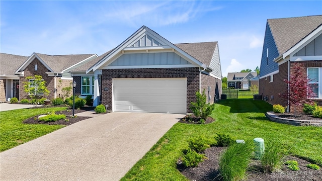 4978 Renaissance Park Dr, Middletown, OH 45005 - view of front of home featuring board and batten siding, brick siding, an attached garage, driveway, and a shingled roof