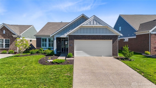 4978 Renaissance Park Dr, Middletown, OH 45005 - view of front facade featuring board and batten siding, brick siding, a front lawn, concrete driveway, and an attached garage