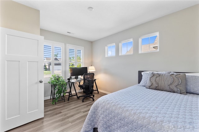 4978 Renaissance Park Dr, Middletown, OH 45005 - bedroom featuring baseboards, light wood-style floors, and a desk