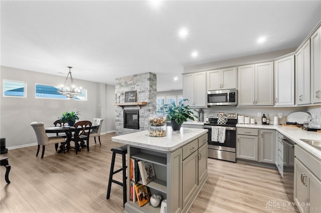 4978 Renaissance Park Dr, Middletown, OH 45005 - kitchen featuring appliances with stainless steel finishes, gray cabinetry, open shelves, a kitchen island, and a chandelier