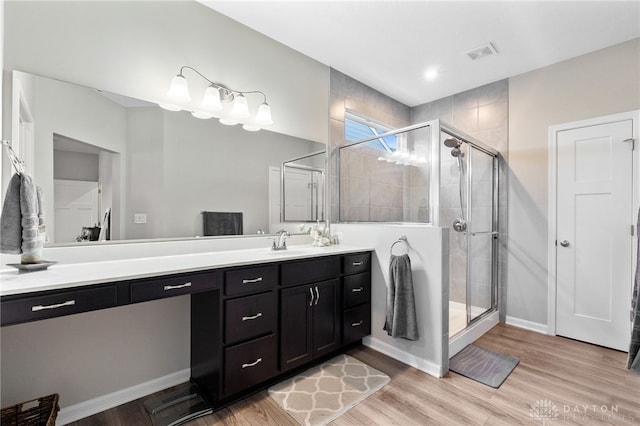 4978 Renaissance Park Dr, Middletown, OH 45005 - bathroom featuring vanity, a stall shower, wood finished floors, and baseboards
