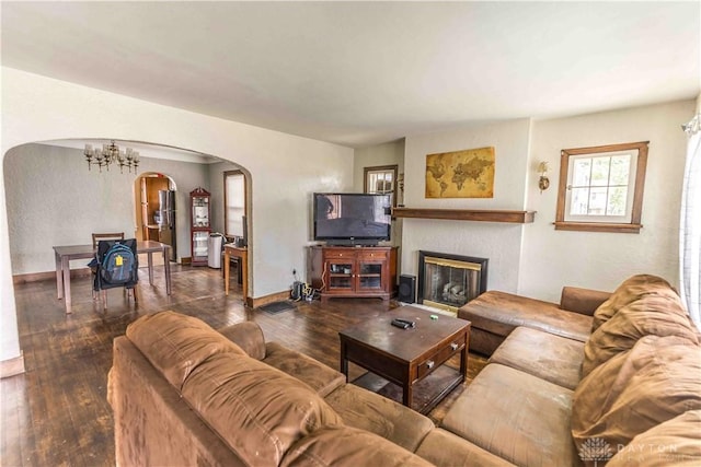 2312 Saint Charles Ave, Dayton, OH 45410 - living area featuring arched walkways, a chandelier, hardwood / wood-style flooring, a fireplace, and baseboards