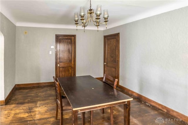 2312 Saint Charles Ave, Dayton, OH 45410 - unfurnished dining area featuring a chandelier, baseboards, arched walkways, and dark wood-style floors