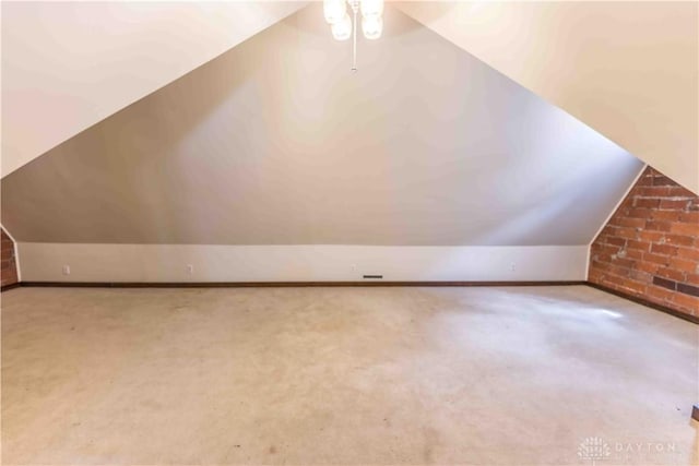 2312 Saint Charles Ave, Dayton, OH 45410 - additional living space featuring vaulted ceiling, carpet floors, a ceiling fan, baseboards, and brick wall