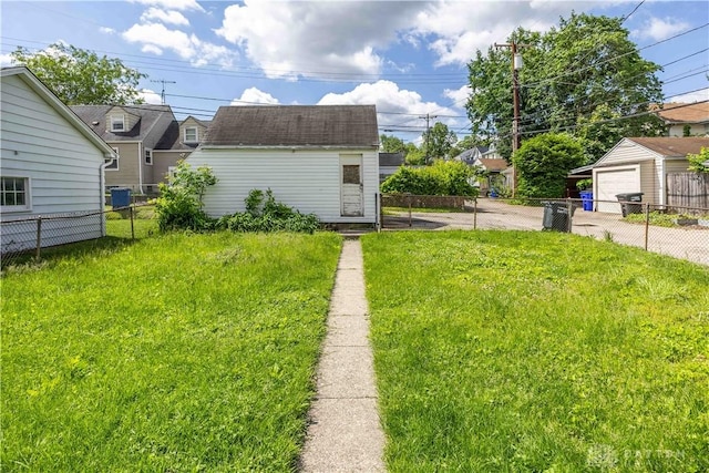 2312 Saint Charles Ave, Dayton, OH 45410 - view of yard featuring a detached garage, an outdoor structure, and concrete driveway