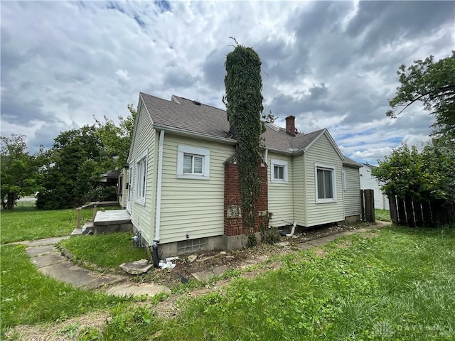 508 W Hillcrest Ave, Dayton, OH 45406 - rear view of house with a chimney, a yard, and a shingled roof