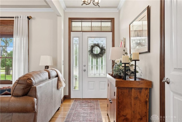 1134 N Webb Rd, Adams Twp, OH 45177 - entrance foyer with light wood-style flooring, ornamental molding, and a chandelier