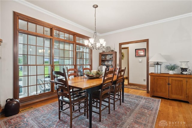 1134 N Webb Rd, Adams Twp, OH 45177 - dining room with a chandelier, light wood-style floors, crown molding, and baseboards