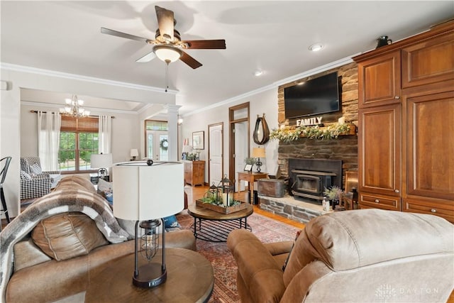 1134 N Webb Rd, Adams Twp, OH 45177 - living area with ornamental molding, ceiling fan, a wood stove, a chandelier, and wood finished floors