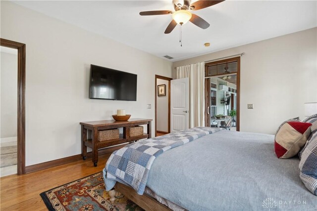 1134 N Webb Rd, Adams Twp, OH 45177 - bedroom with wood finished floors, baseboards, ceiling fan, and access to exterior
