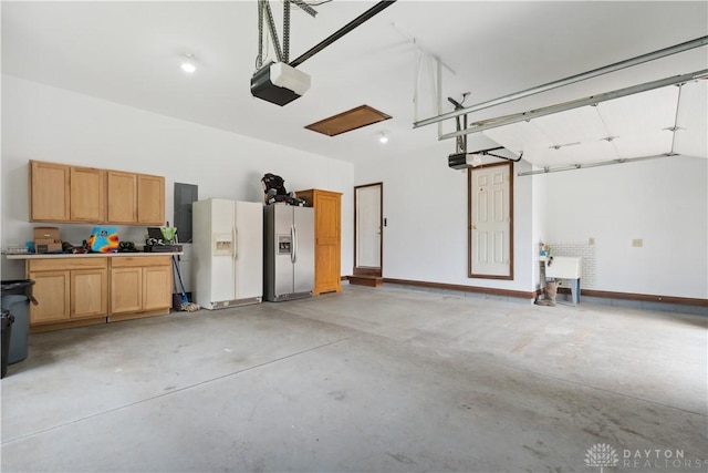 1134 N Webb Rd, Adams Twp, OH 45177 - garage with white refrigerator with ice dispenser, stainless steel refrigerator with ice dispenser, a garage door opener, and baseboards