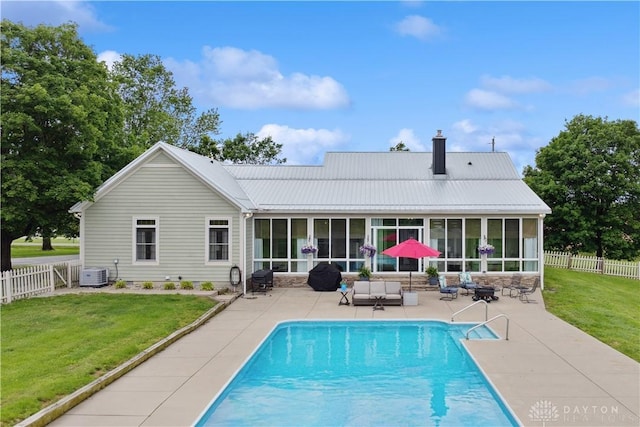 1134 N Webb Rd, Adams Twp, OH 45177 - back of property with a sunroom, cooling unit, a chimney, a patio area, and metal roof
