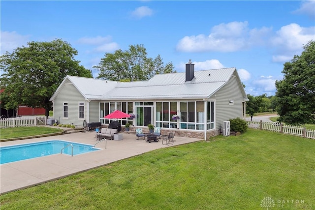 1134 N Webb Rd, Adams Twp, OH 45177 - back of house featuring a chimney, a sunroom, a patio, and metal roof