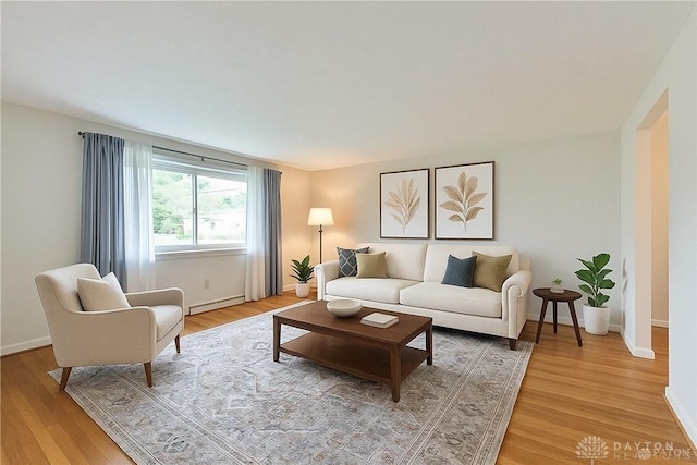 300 Magnolia Ave, Englewood, OH 45322 - living room with a baseboard radiator, light wood-type flooring, and baseboards