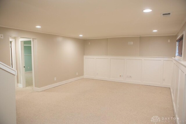 316 Honey Jane Dr, Beavercreek, OH 45434 - empty room with light colored carpet, recessed lighting, a decorative wall, crown molding, and a wainscoted wall