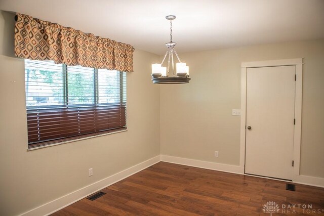 316 Honey Jane Dr, Beavercreek, OH 45434 - empty room featuring a chandelier, baseboards, and dark wood finished floors