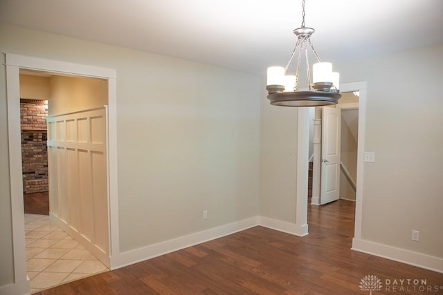 316 Honey Jane Dr, Beavercreek, OH 45434 - empty room featuring a chandelier, wood finished floors, and baseboards