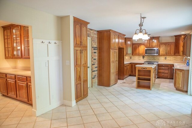 316 Honey Jane Dr, Beavercreek, OH 45434 - kitchen featuring appliances with stainless steel finishes, decorative backsplash, light countertops, brown cabinetry, and open shelves