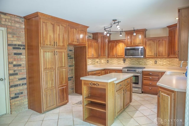 316 Honey Jane Dr, Beavercreek, OH 45434 - kitchen featuring stainless steel appliances, a sink, a center island, open shelves, and light countertops