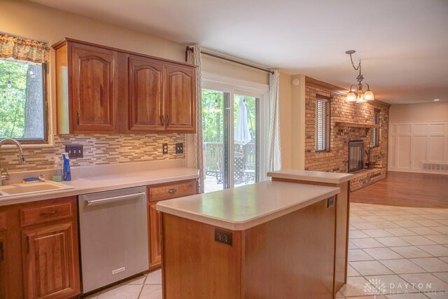 316 Honey Jane Dr, Beavercreek, OH 45434 - kitchen featuring stainless steel dishwasher, a sink, light countertops, light tile patterned flooring, and tasteful backsplash