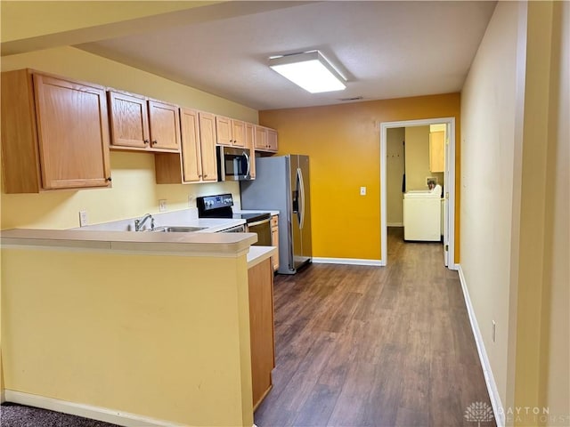 5023 Crescent Ridge Dr, Clayton, OH 45315 - kitchen with appliances with stainless steel finishes, washer / dryer, dark wood-style floors, and a sink