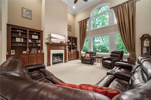 7607 Stone Ridge Dr, Springboro, OH 45066 - living room featuring a high ceiling, carpet floors, ornamental molding, a tiled fireplace, and plenty of natural light