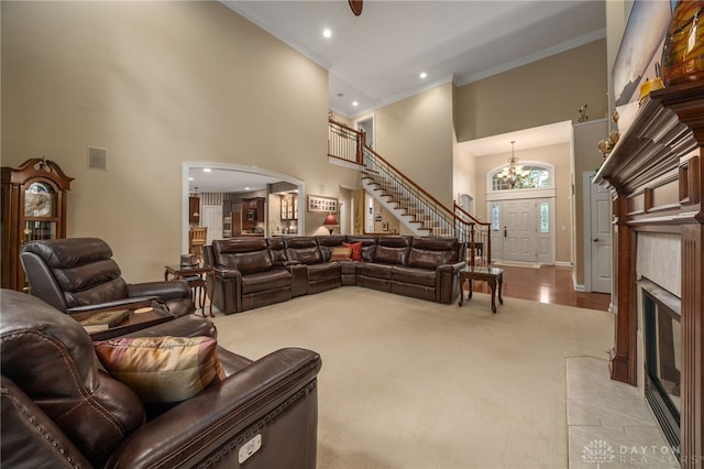 7607 Stone Ridge Dr, Springboro, OH 45066 - carpeted living room with a towering ceiling, ornamental molding, baseboards, recessed lighting, and a chandelier