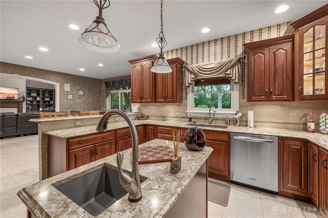 7607 Stone Ridge Dr, Springboro, OH 45066 - kitchen featuring dishwasher, a sink, light tile patterned flooring, recessed lighting, and light stone countertops