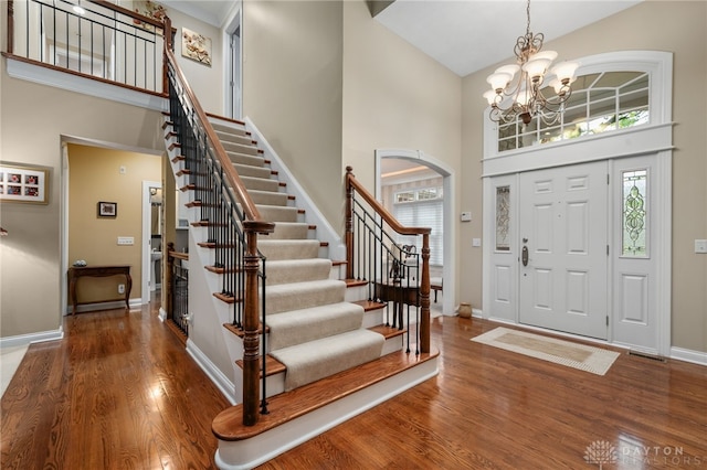 7607 Stone Ridge Dr, Springboro, OH 45066 - foyer entrance with a towering ceiling, stairs, wood finished floors, plenty of natural light, and baseboards