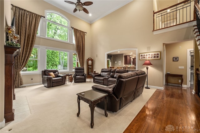 7607 Stone Ridge Dr, Springboro, OH 45066 - carpeted living area featuring baseboards, a ceiling fan, ornamental molding, a towering ceiling, and healthy amount of natural light