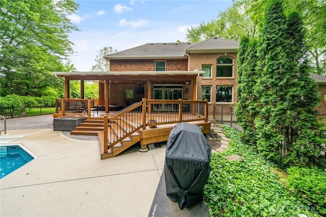 7607 Stone Ridge Dr, Springboro, OH 45066 - rear view of property featuring a patio, a wooden deck, brick siding, and roof with shingles