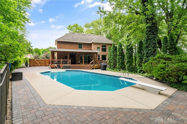 7607 Stone Ridge Dr, Springboro, OH 45066 - view of pool with a wooden deck, a diving board, a gate, and a patio