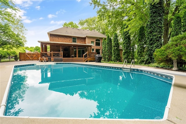 7607 Stone Ridge Dr, Springboro, OH 45066 - outdoor pool with a deck, a gate, and area for grilling