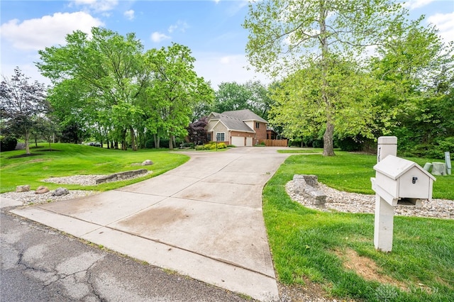 7607 Stone Ridge Dr, Springboro, OH 45066 - view of front of house with a front lawn, driveway, and a garage