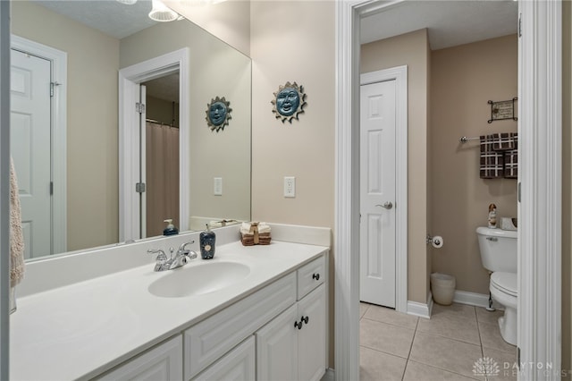 7607 Stone Ridge Dr, Springboro, OH 45066 - bathroom with toilet, tile patterned floors, vanity, and baseboards
